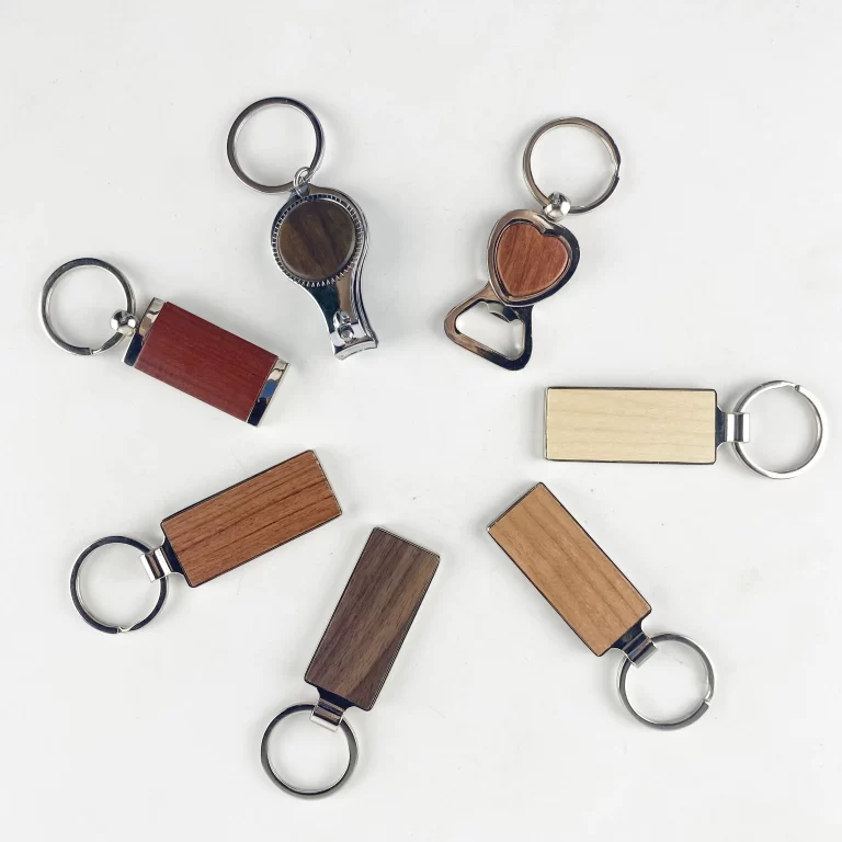 Wood keychains in several shapes and wood tones, ready to engrave as favors